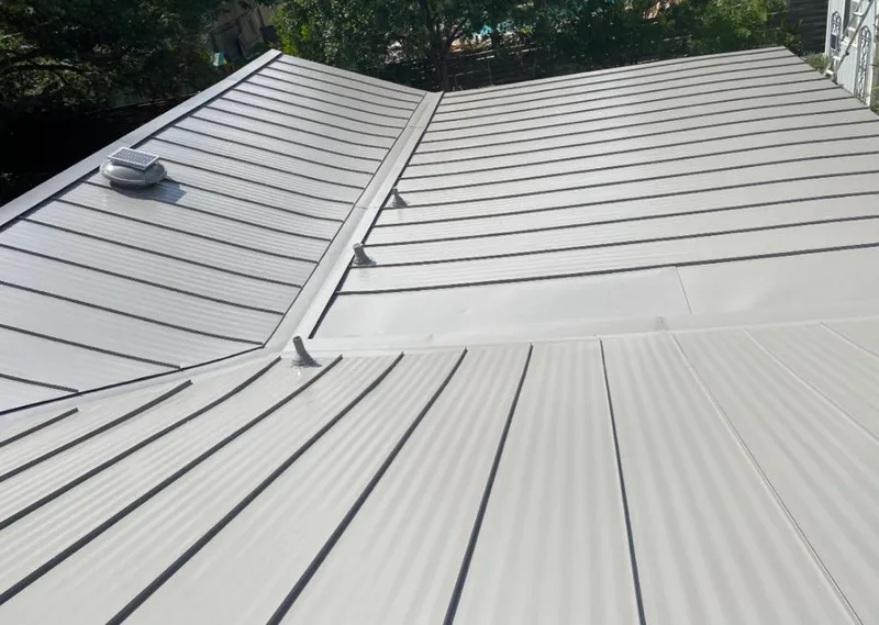 Solar attic fan installed on a metal roof for Roof Ventilation in Grand Forks